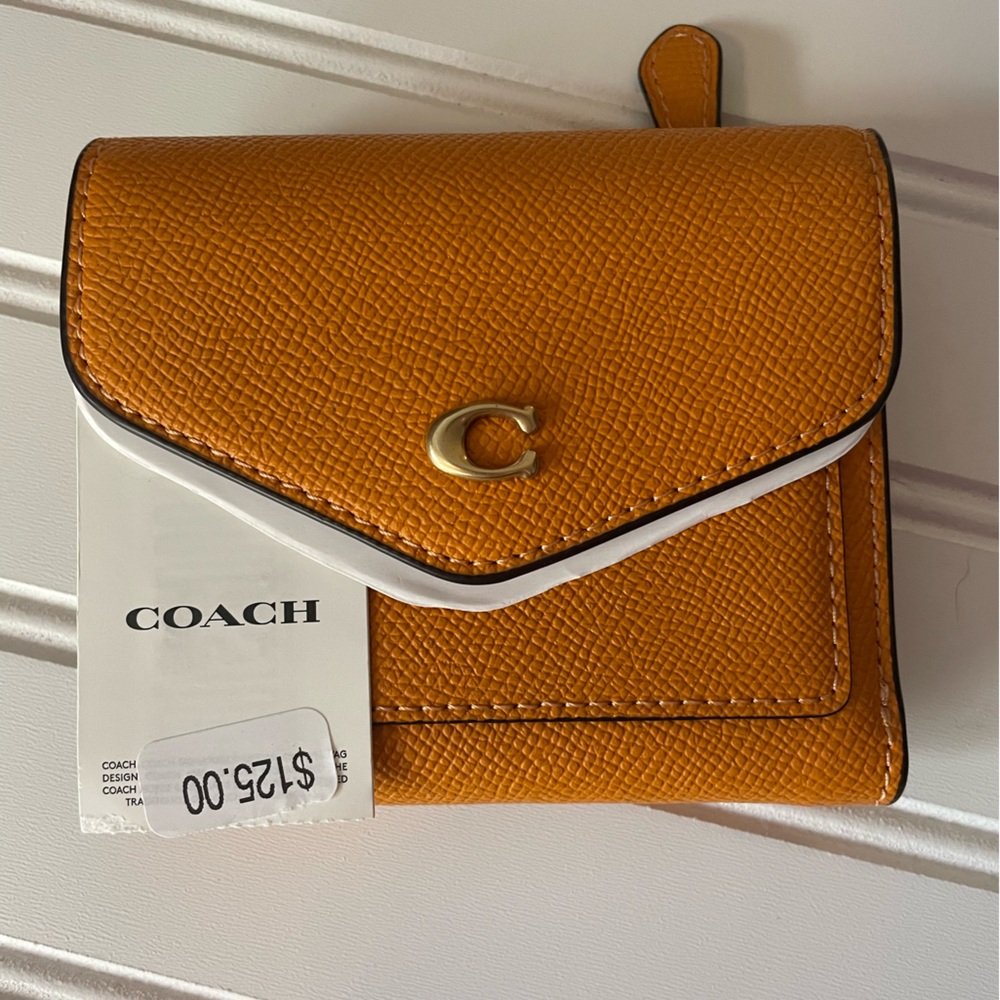 NWT Coach yellow leather wallet. Purchased @Dillards brand new. Originally $125.